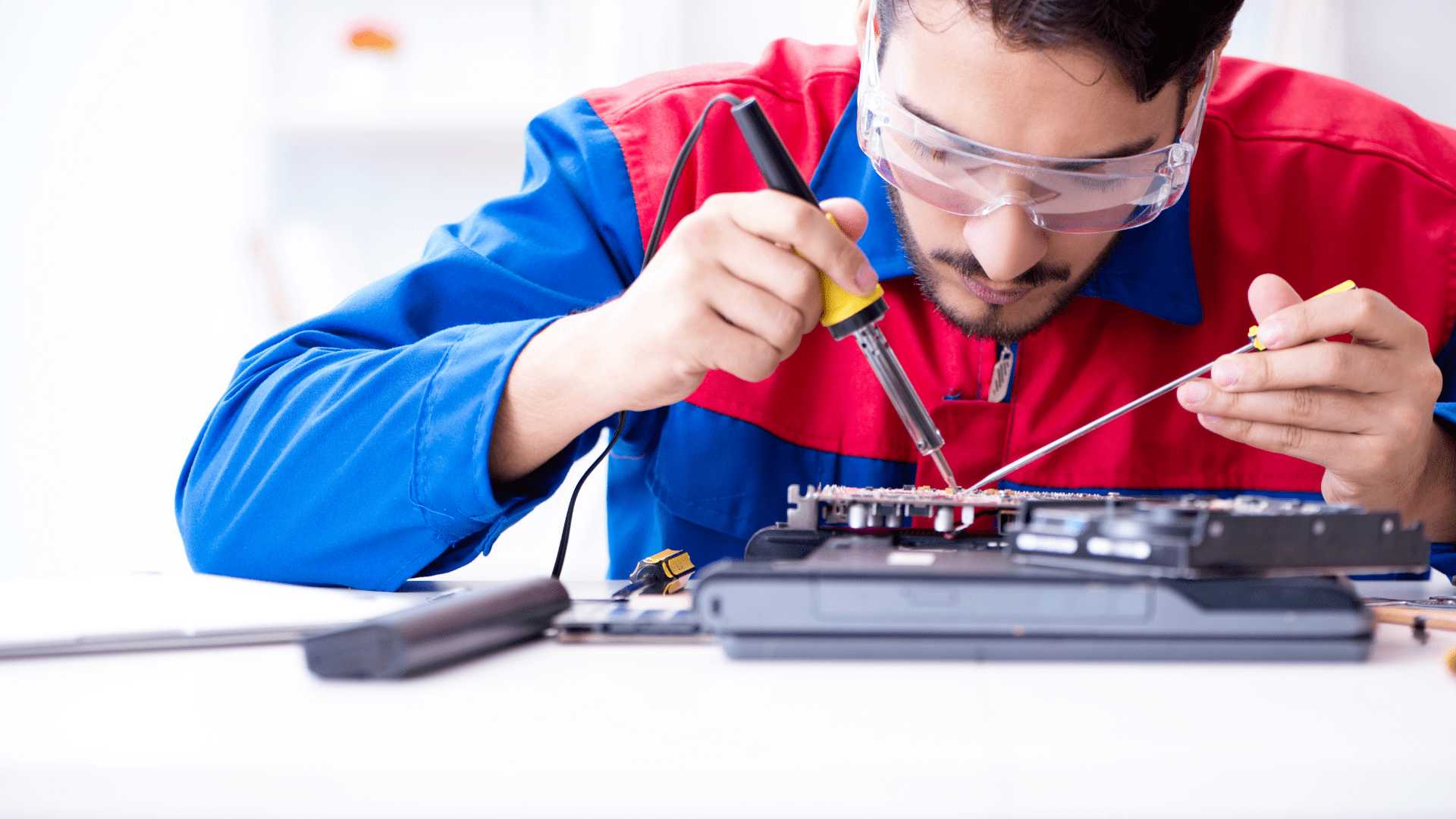 Technician repairing laptop hardware